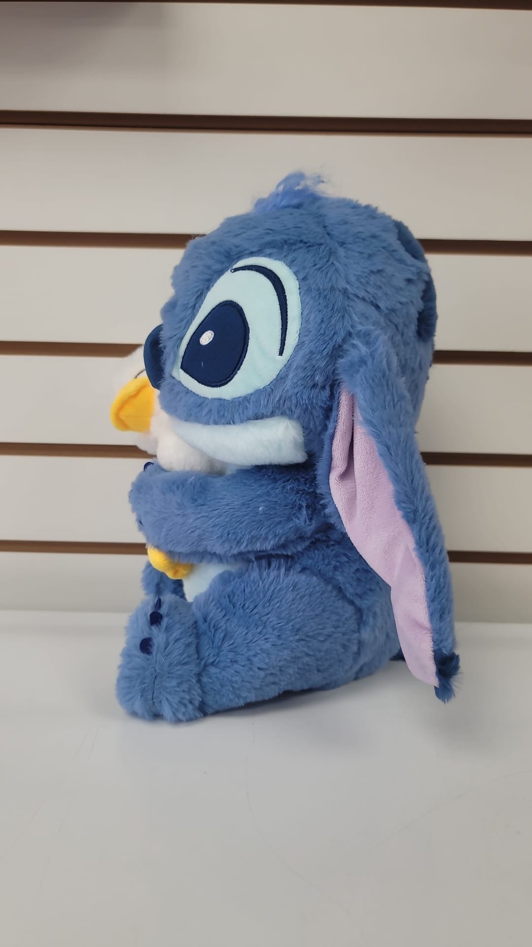 Plush blue stitch hugging duck