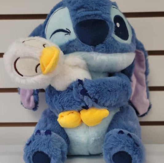 Plush blue stitch hugging duck