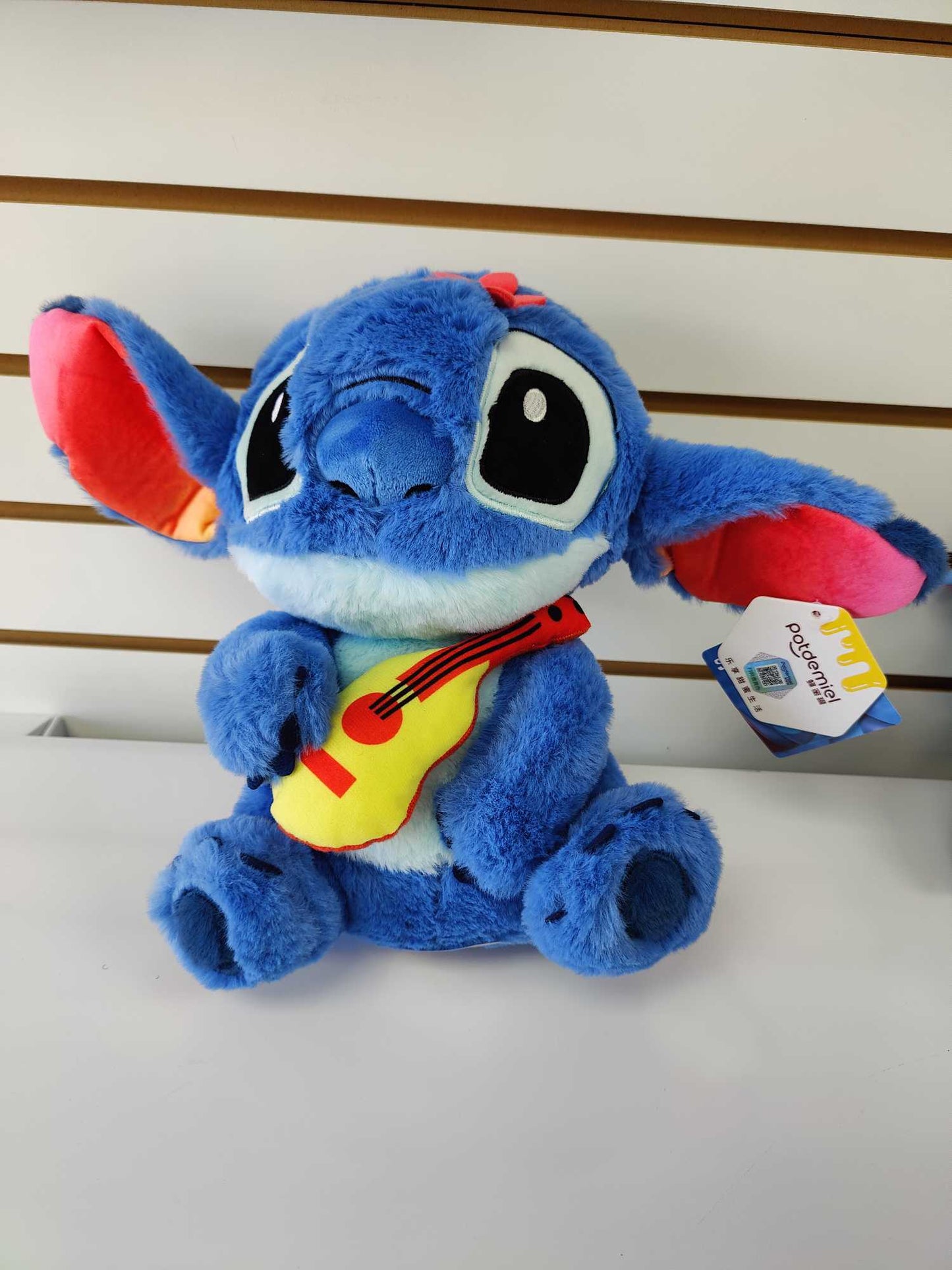 Plush Guitar playing Stitch with flower in head.